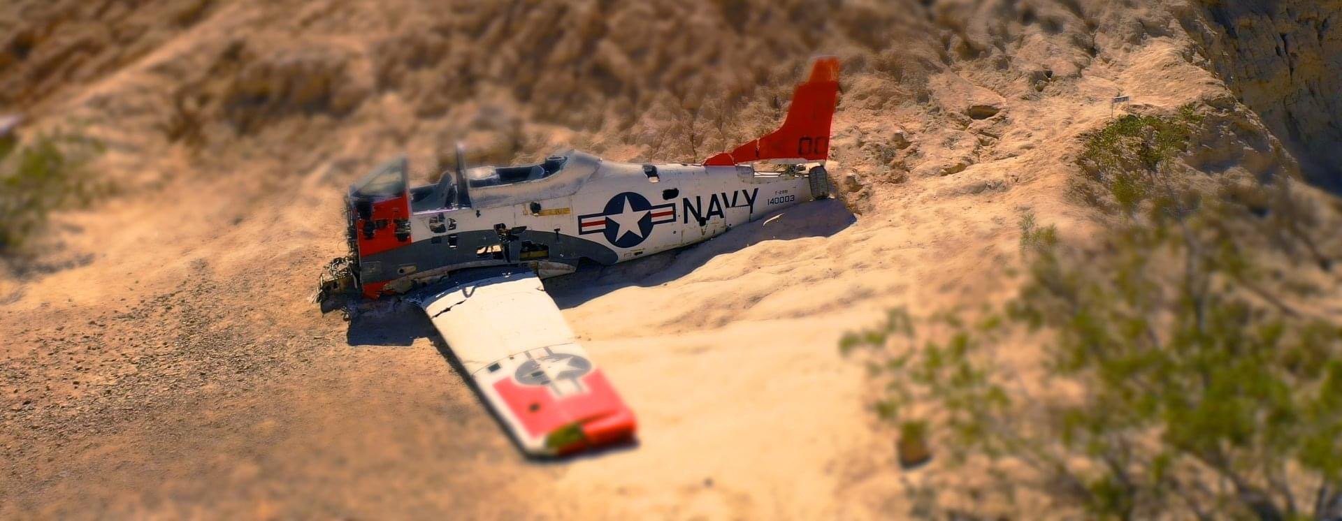 Aerial view of crashed Navy plane in desert canyon
